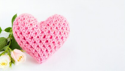 crocheted pink heart on a white background