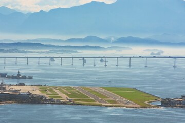 Santos Dumont Airport. Rio de janeiro Brazil. Plane landing on the runway. In the background the...