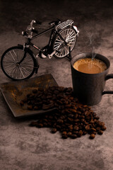Hot coffee in an old metal mug with coffee beans