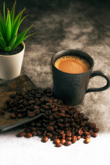 Hot coffee in an old metal mug with coffee beans