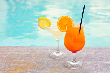 Glasses of tropical cocktail on poolside