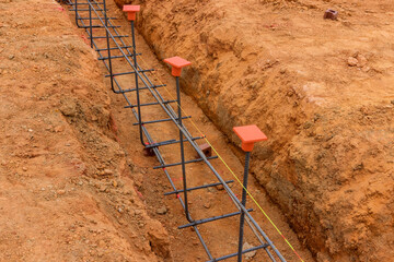Variety earthwork is performed, including excavation an earthen trench for foundations pouring of concrete