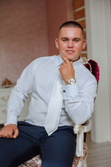 A stylish portrait of the groom preparing for the wedding ceremony in the morning. Groom's morning....