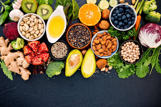 Ingredients for the healthy foods selection. The concept of healthy food set up on dark stone background.