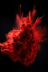 Explosion of crimson red colored powder on black background