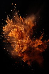 Explosion of bronze colored powder on black background
