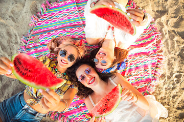 Female friends eating watermelon