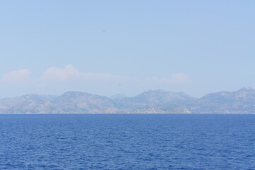 Sea with mountains in the background