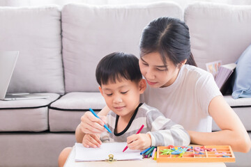 Happy Asian single mother spent time teaching little boy counting numbers by using finger, kid has fun enjoy playing with mom love bonding relationship, homeschool education or motherhood nurturing
