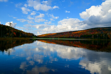 Fall scene Shavers Lake in the Fall with blue sky and puffy white clouds