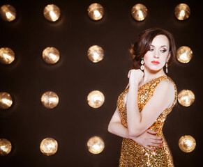 Superstar woman wearing golden shining dress