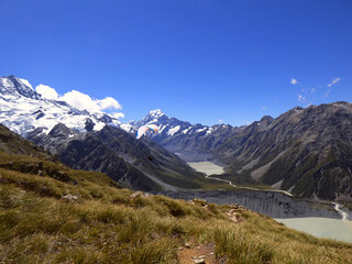 Mueller hut track, Aoraki National park, New Zealand. Southern Alps and Mt. Cook in the background, glacial lake in the front. Sunny day in the summer with clear skies and beautiful view.