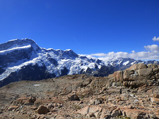 Landscape photograph of Mueller hut track, Aoraki National park, New Zealand. Southern Alps and Mt. Cook in the background. Sunny day in the summer with clear skies and beautiful view.