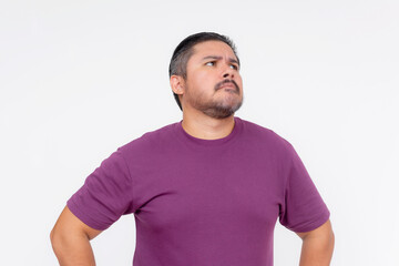 Obraz premium A middle aged man looking dumbfounded, looking to the right. Wearing eyeglasses and a purple waffle shirt, Isolated on a white background.