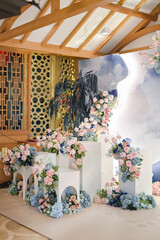 Modern chinese decoration for wedding ceremony or enggament. Blue pink rose. Indoors. Stage. Held on restaurant or ballroom. Chinesse caligraphic double happiness. Celebration. Private party. Dinner.