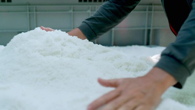 Bretagne Salzg&auml;rten Gu&eacute;rande abgeschoepftes Fleur de Sel rinnt durch die H&auml;nde