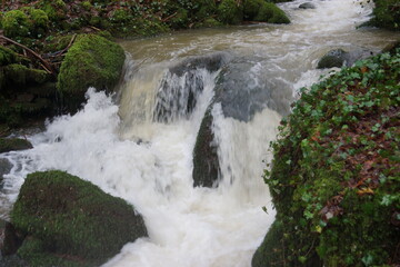 Ein Bach nach ergiebigen Regen mit Felsen und Steinen und ein Bach ohne Wasser nur Steine
