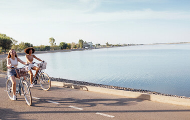 Fototapeta premium Teenagers of different nationalities and appearance on bicycles ride along a city street