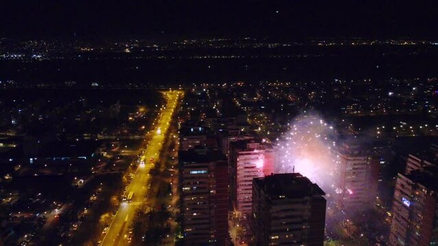 Colorful New Year fireworks over building in a city
