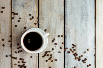 Cup of coffee on the table and texture of coffee beans. coffee beans with  space for text or ideas. coffee concept.