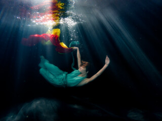 Halee Grindo swimming underwater with long dresss and chiffon