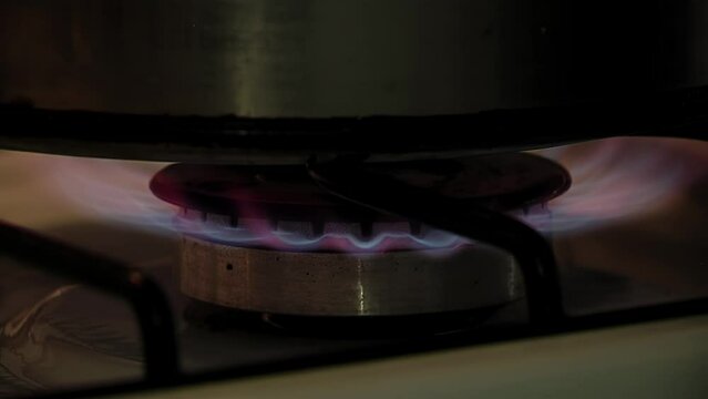 Gas Cooktop Flame, Gas stove, A Man Using a Lighter To Ignite a Kitchen Stove. Close Up.