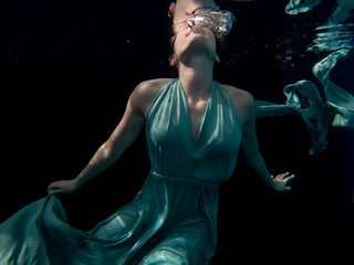 Halee Grindo swimming underwater with long dresss and chiffon