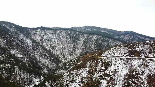 Beautiful nature footage of a mountains covered in snow and evergreen trees