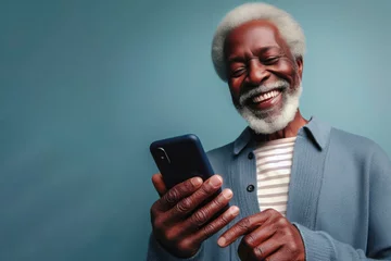 Foto op Plexiglas An elderly black man smiling and laughing with his phone against a colored background. ai generative © Anna