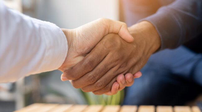 close up investor businessman handshake with partner or vendor after the completed acquisition and collaboration of two ceo leader for make agreement or deal financial cooperative concept