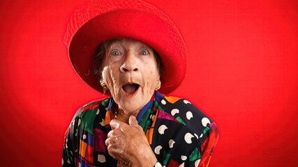 Funny portrait of happy elderly senior woman with no teeth pointing fingers herself ask say call...