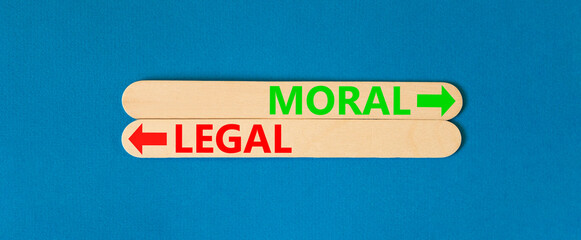 Moral or legal symbol. Concept word Moral or Legal on beautiful wooden stick. Beautiful blue table...