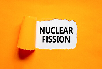 Nuclear fission symbol. Concept words Nuclear fission on beautiful white paper. Beautiful orange paper background. Business science nuclear fission concept. Copy space. - obrazy, fototapety, plakaty