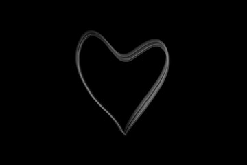 heart shape in moke spreading isolated on dark background