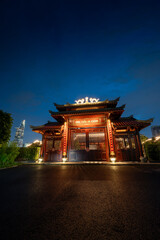 Obraz premium view of An Khanh temple and Ho Chi Minh City skyline. Amazing colorful night view of skyscraper and other modern buildings at downtown. Travel concept