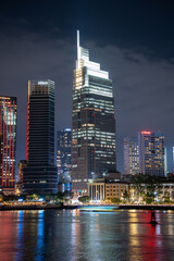 Ho Chi Minh City skyline and the Saigon River. Amazing colorful night view of skyscraper and other modern buildings at downtown. Travel concept