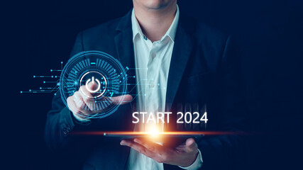 Businessman touch the on/off switch on a virtual screen to start the New Year of 2024, Start up...