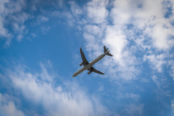 Commercial Airplane Flying High Above Clouds