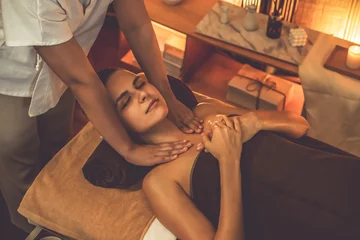 Gardinen Caucasian woman customer enjoying relaxing anti-stress spa massage and pampering with beauty skin recreation leisure in warm candle lighting ambient salon spa at luxury resort or hotel. Quiescent © Summit Art Creations