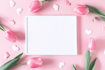 Flowers composition romantic. Flowers pink tulips, photo frame on pastel pink background. Wedding....