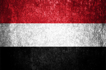 Close-up of Yemen grunge flag. Dirty Yemen flag on a metal surface.