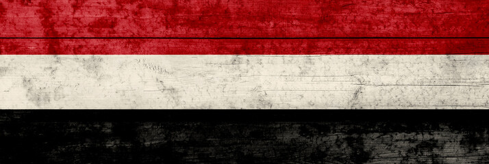 Yemen flag on a wooden surface. Yemen grunge flag.