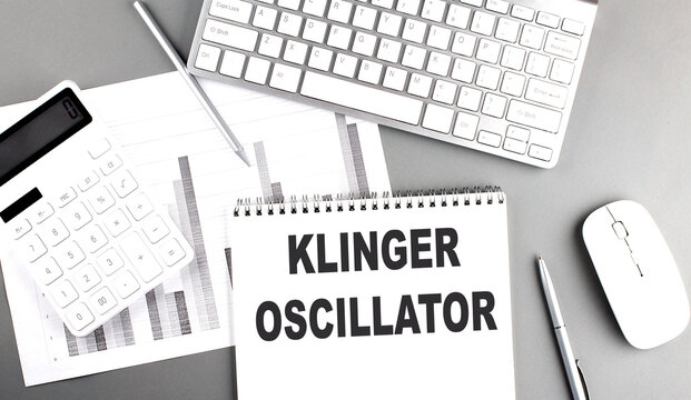 Klinger Oscillator text on notebook with calculator , chart and keyboard business concept