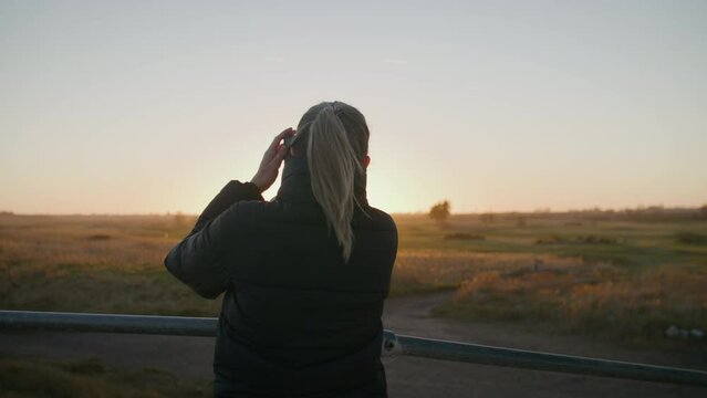 A girl taking photos during sunset.
Frinton, UK