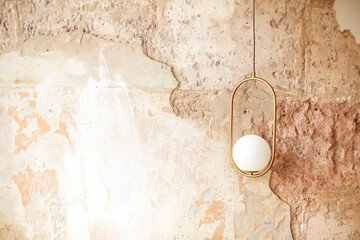 Stylish lamp on shabby wall
