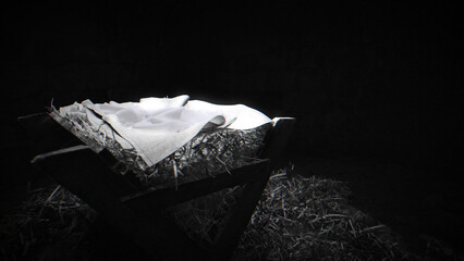 Black and white shot of the manger, dimly top lit, film grain.