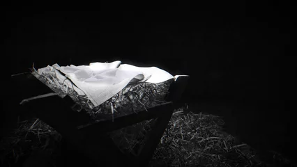 Zelfklevend Fotobehang Black and white shot of the manger, dimly top lit, film grain. © Chris