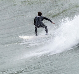 a surfer surf a wave in italy