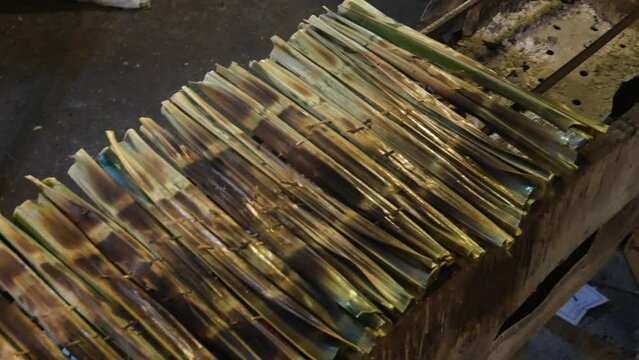 Thai sweetmeat made of flour, coconut and sugar and wrapped with nipa palm leaf (Kanom Chak). 