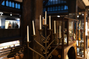 Wooden candlestick with seven candles in the shape of a slide.